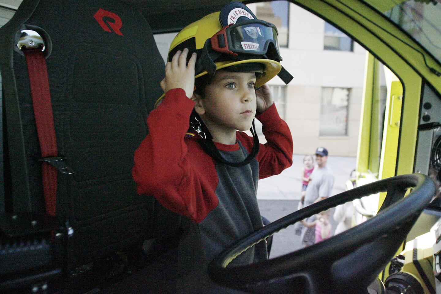 Henry Hadinger, 6, rides in the Rosenbauer Panther during Fire Service Day in Burbank on Saturday, May 12, 2012.