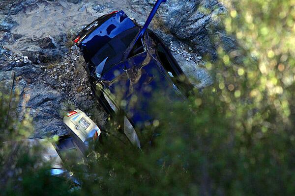 La Vau's blue Toyota Corolla is seen crushed in a ravine. Authorities say they believe the silver car, which was found with a man's body inside, had plummeted off the cliff a few days before La Vau. See full story