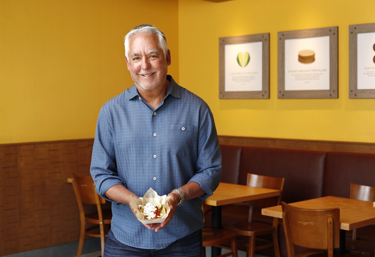 Ralph Rubio, founder of the Rubio’s Coastal Grill chain, displays the signature dish he helped popularize.