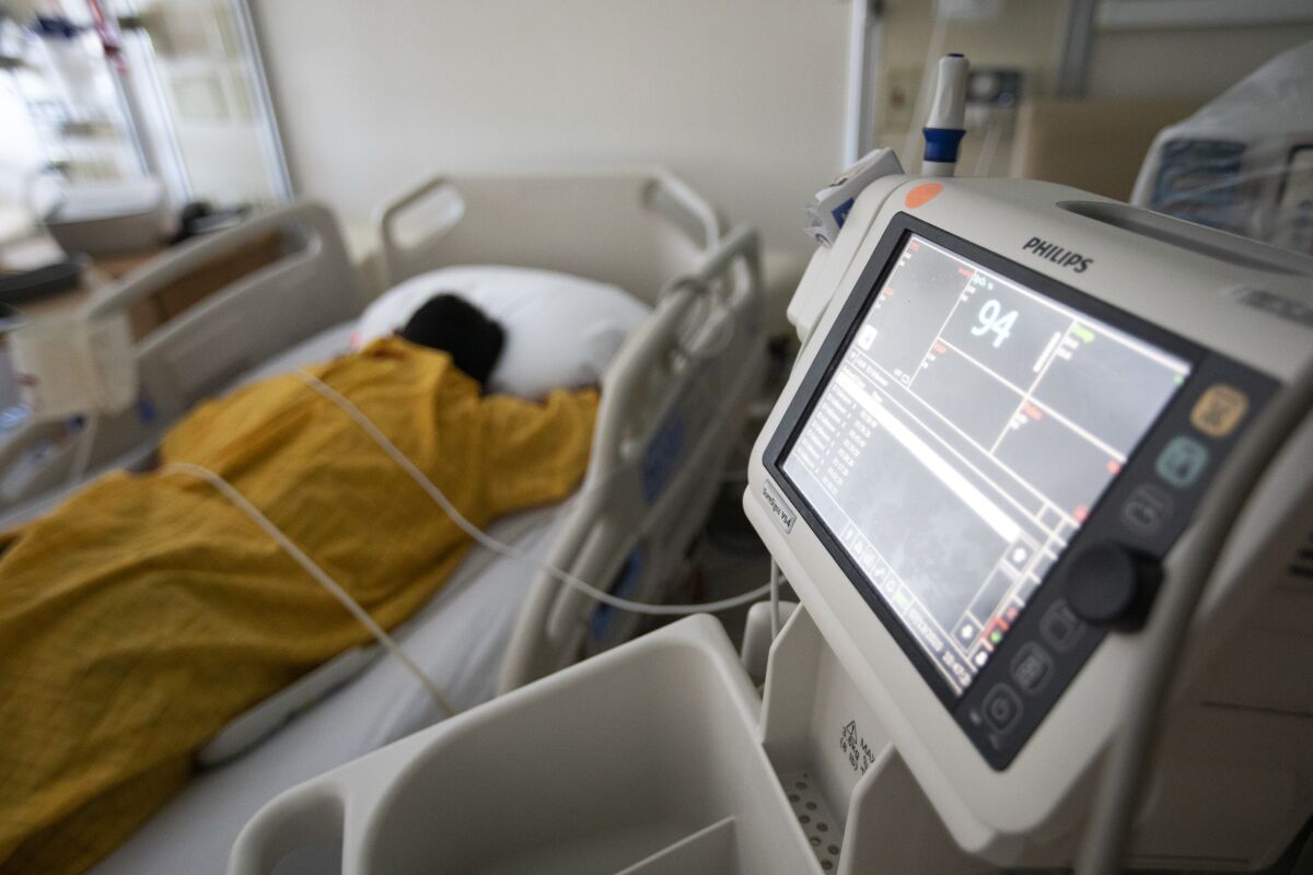 A COVID-19 patient in a hospital bed