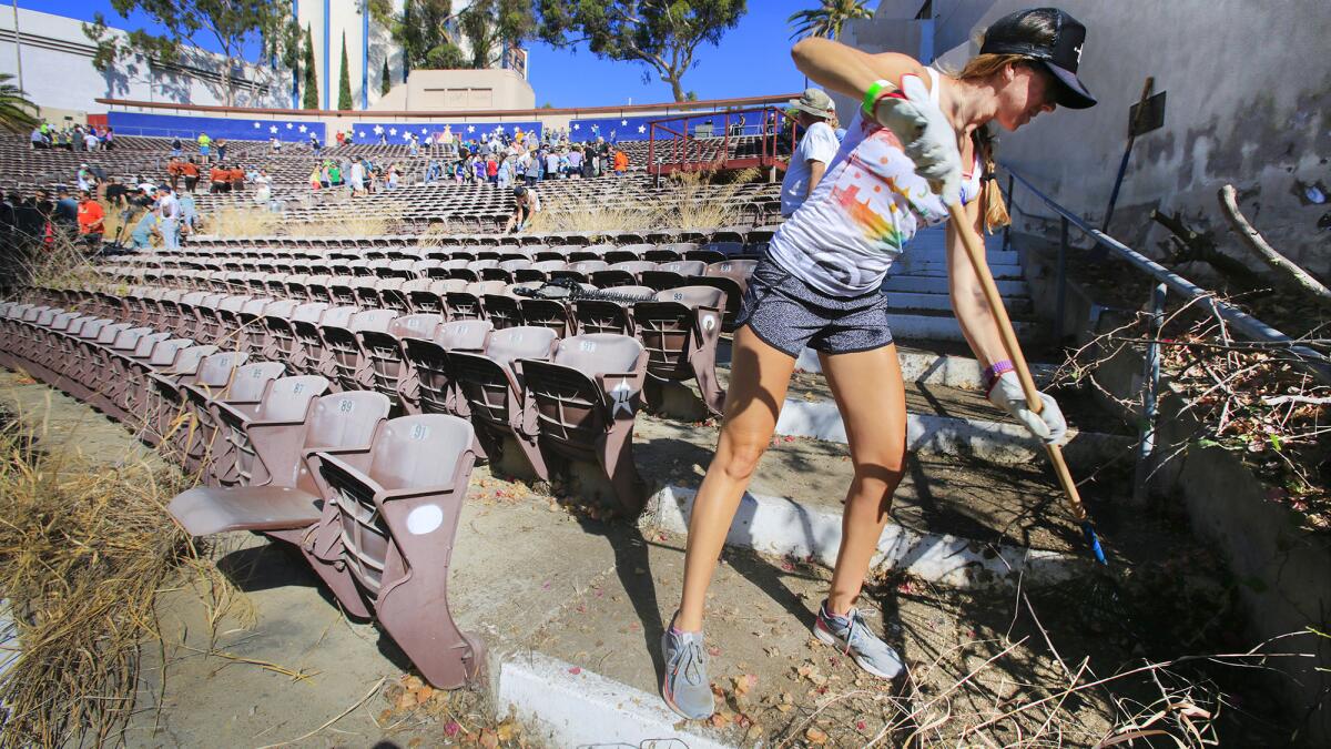 Lindsay Appelbaum of La Jolla helps clear out weeds and debris at the Starlight Bowl amphitheater in Balboa Park.