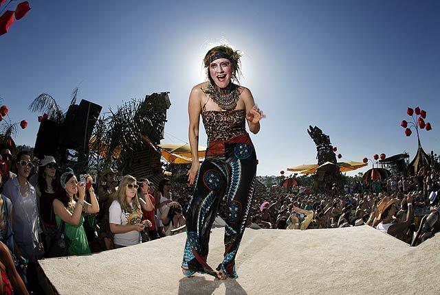 Jesselynn Desmond, a performer with the Lucent Dossier Vaudeville Circus Troupe, entertains festival-goers on the Coachella grounds Friday afternoon.