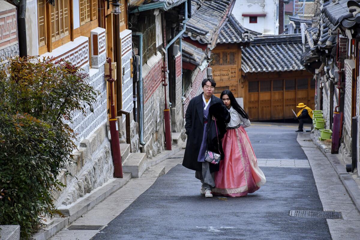 Tourists tread lightly and whisper when visiting Bukchon Hanok Village in Seoul, a compound of 100-year-old houses that are still occupied.