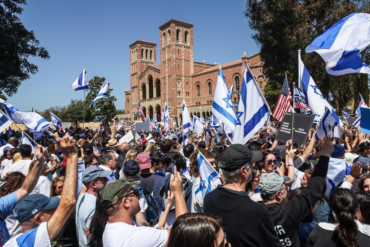 Students hold signs and Israeli flags during a demonstration near UCLA's Royce Hall