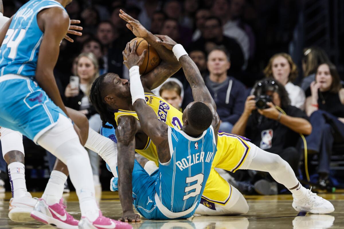 Lakers forward Taurean Prince battles Charlotte Hornets guard Terry Rozier for a loose ball.