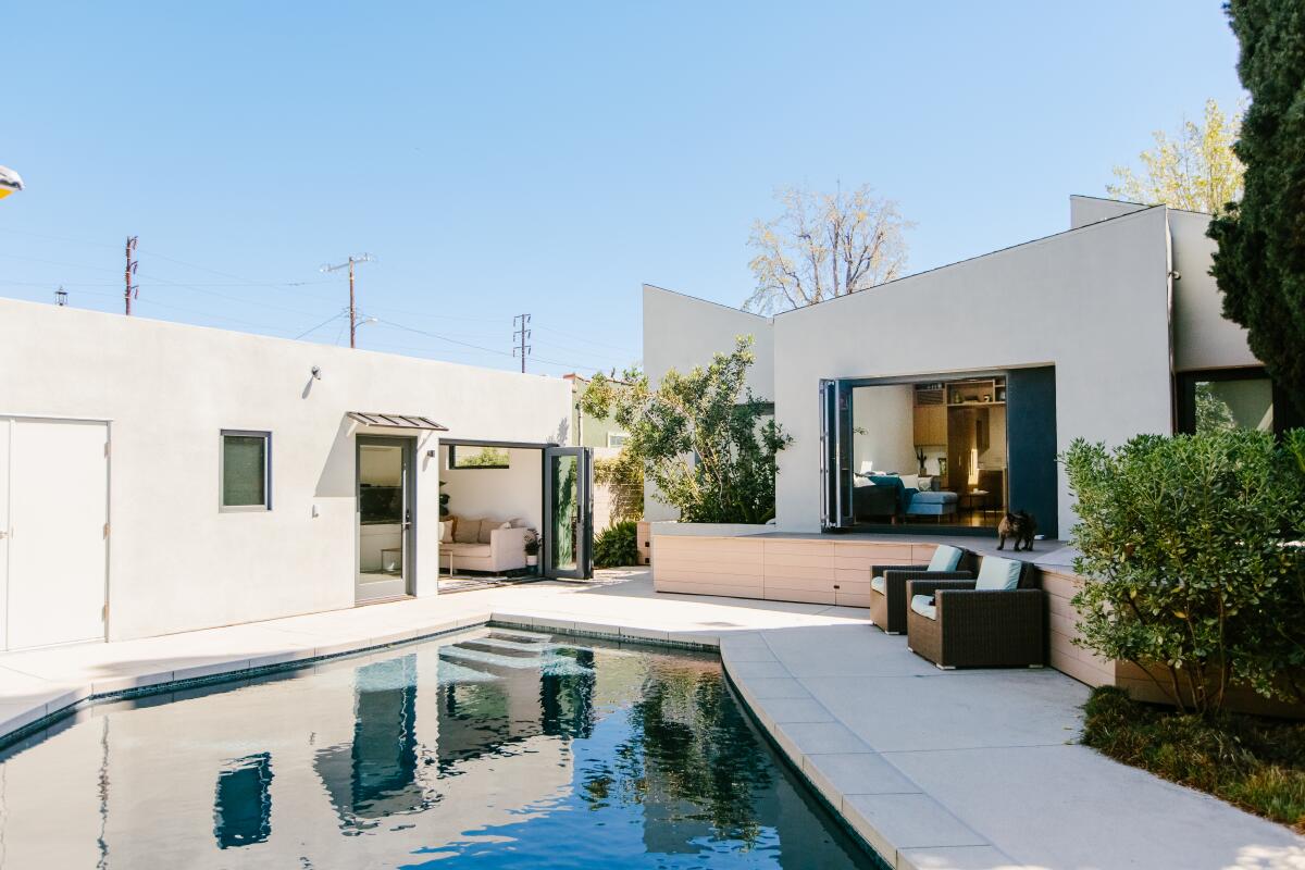 Two buildings around a pool.