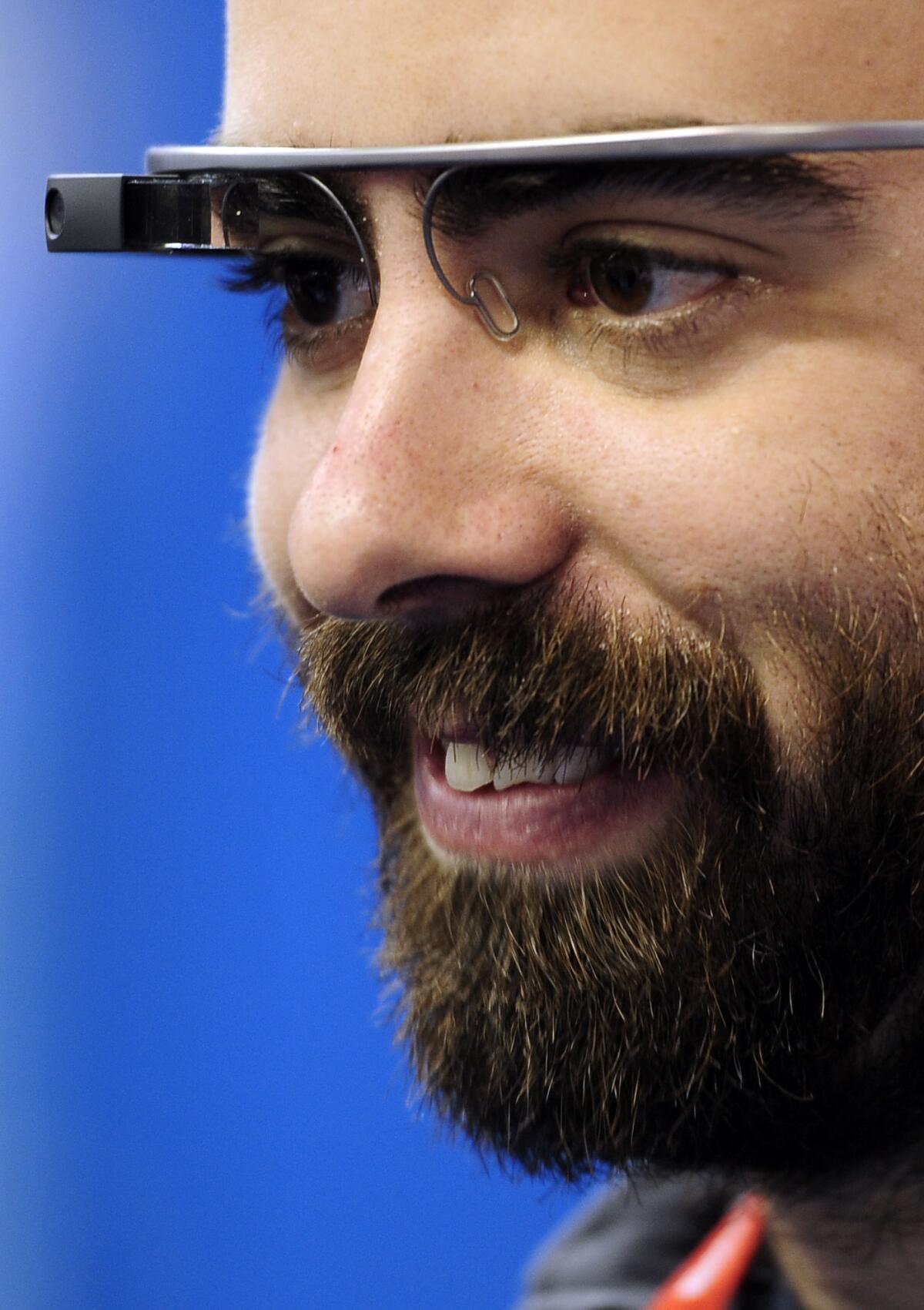 A visitor uses the Google Glass at the Mobile World Congress, the world's largest mobile phone trade show, in Barcelona, Spain. Privacy concerns have prompted some businesses to prohibit them.