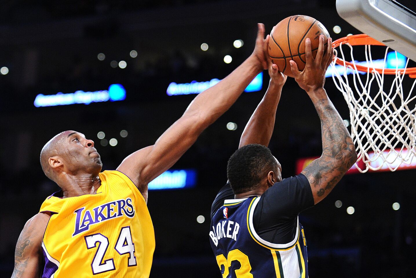 Kobe Bryant blocks a shot by Trevor Booker in his final game at Staples Center on Wednesday.