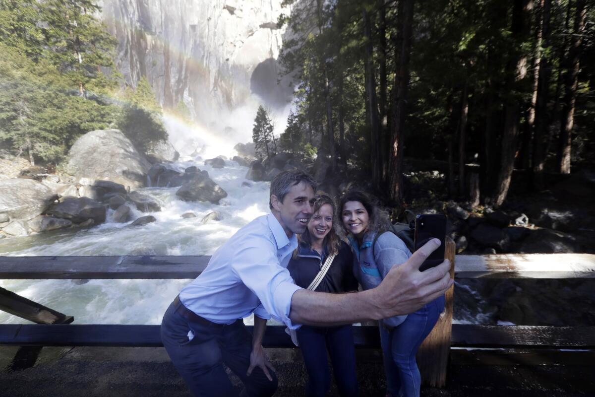 Former Texas congressman Beto O'Rourke takes a selfie with Anne Kelly, center, director of the Sierra Nevada Research Stations, and environmental advocate Leslie Martinez in Yosemite National Park.
