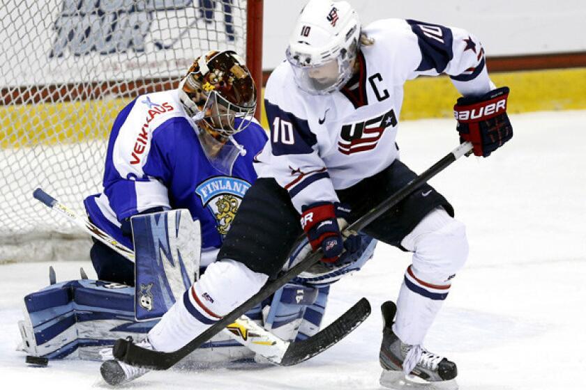 U.S. captain Meghan Duggan looks to score near the crease against Finland goalie Noora Raty during the third period of a Four Nations Cup game this fall.