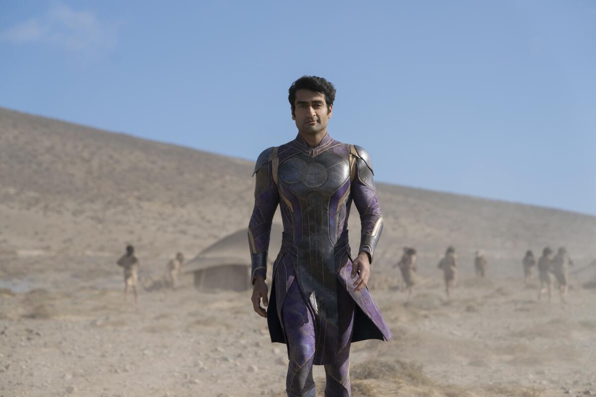 A man in unusual dress walks through the desert in "Eternals."