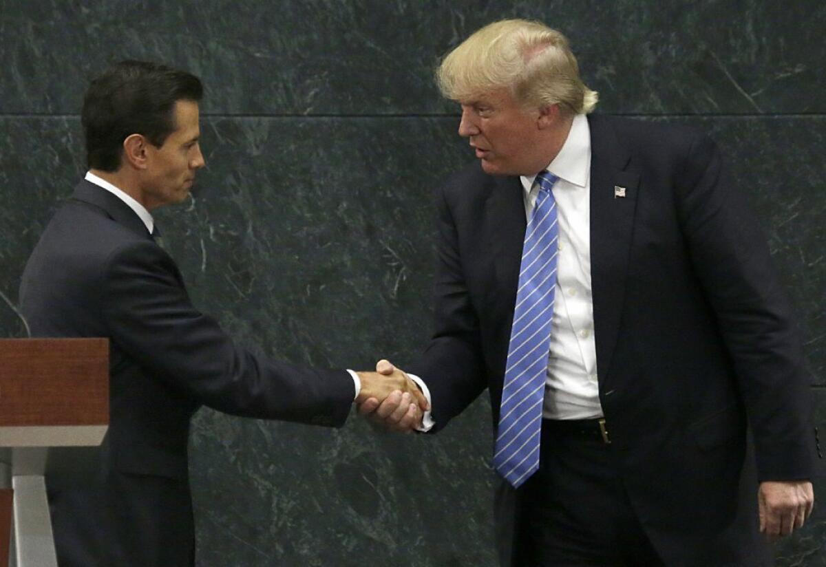 Mexico's President Enrique Peña Nieto, left, and then Republican presidential nominee Donald Trump meet in August in Mexico City. The meeting came to haunt Peña Nieto, whose ratings plummeted.
