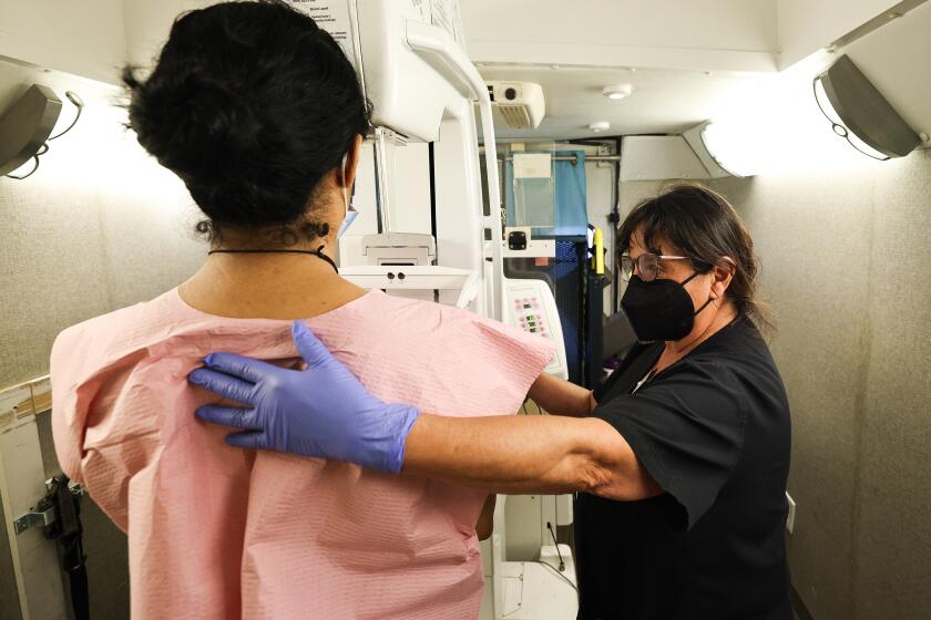 San Diego, CA - September 12: Mammogram technician Debbie Cardenas prepares Flor Esquivel for a mammogram during a health fair at San Diego American Indian Health Center on Tuesday, Sept. 12, 2023 in San Diego, CA. (Meg McLaughlin / The San Diego Union-Tribune)