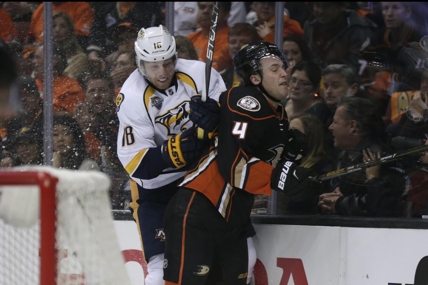 Ducks defenseman Cam Fowler is checked by Predators winger James Neal during the first period of Game 1.