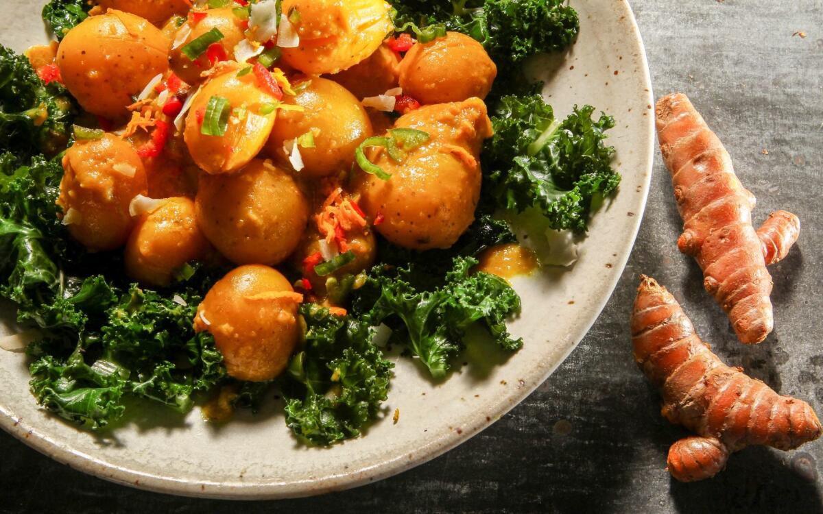 Turmeric-braised baby potatoes with coconut kale