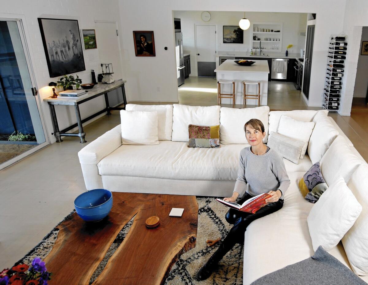Amanda Pays, who often lives in the houses she renovates and sells, loves the way the kitchen connects to the living room.