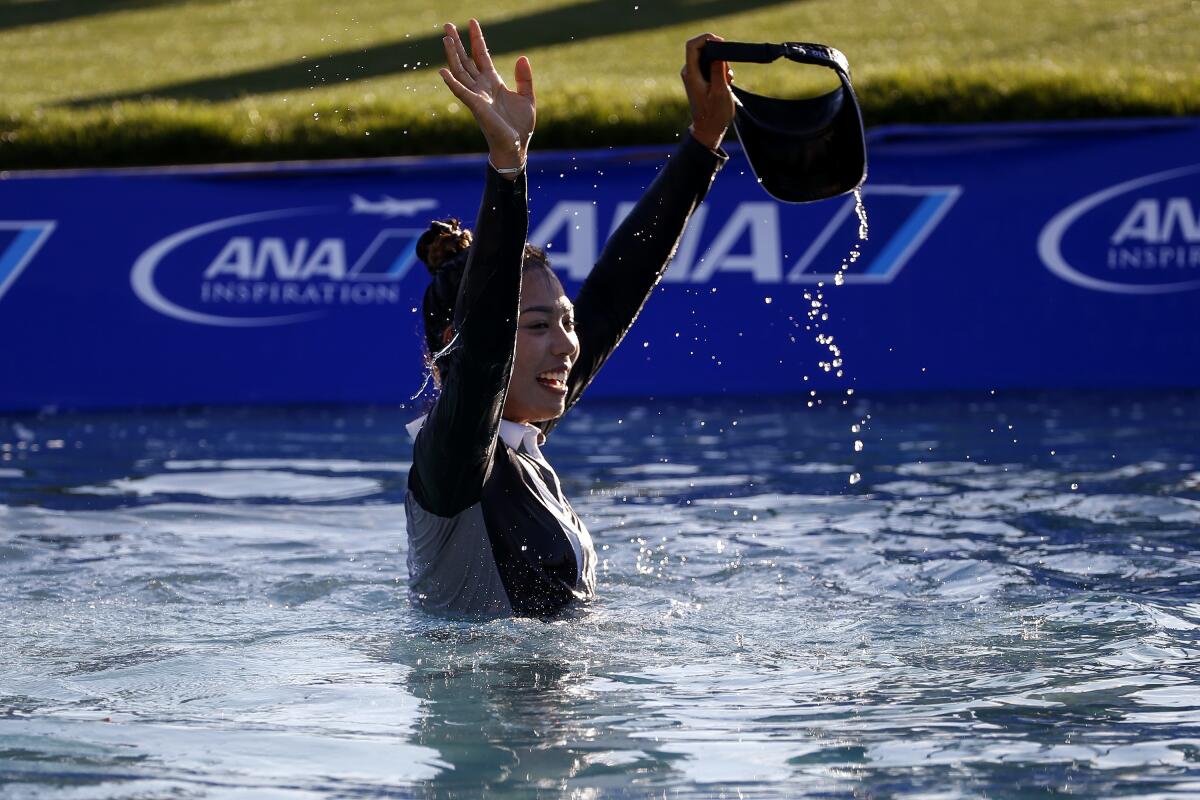 Patty Tavatanakit waves after jumping into the water after winning the LPGA's ANA Inspiration on Sunday.