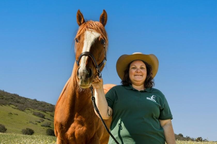 Allie Sarnataro, executive director of Ride Above Disability Therapeutic Riding Center in Poway, poses with Jessie.