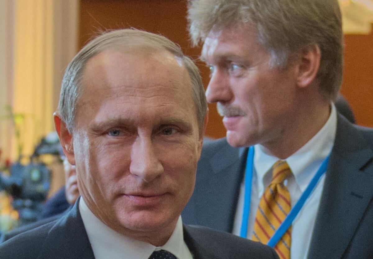 Russian President Vladimir Putin, left, and Kremlin spokesman Dmitry Peskov attend the Commonwealth of Independent States leaders summit Oct. 16.