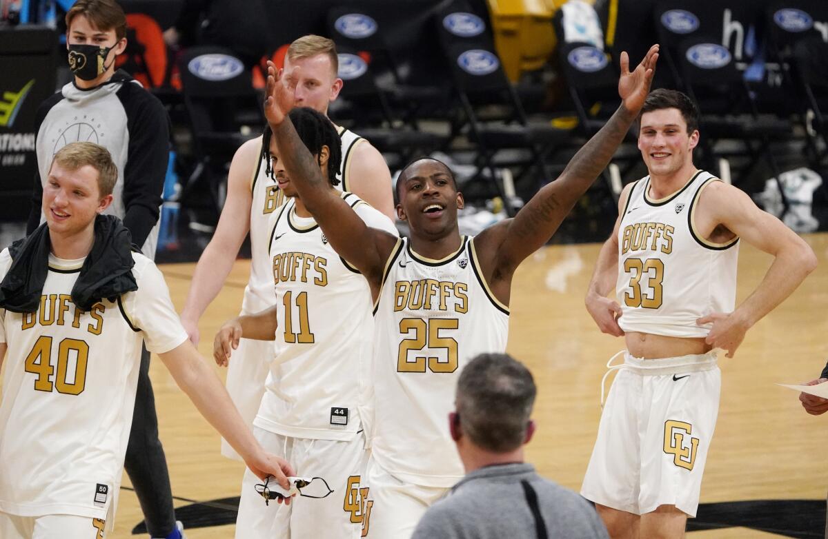 Colorado guard McKinley Wright IV, front center, acknowledges the small crowd as he leaves the court with teammates after an NCAA college basketball game against Arizona State, Thursday, March 4, 2021, in Boulder, Colo. (AP Photo/David Zalubowski)