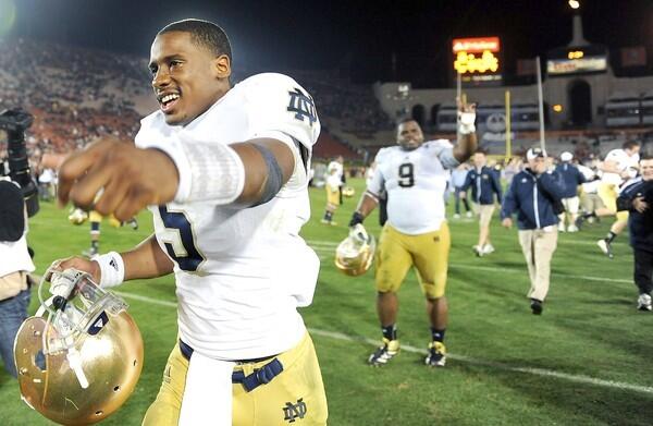 Notre Dame quarterback Everett Golson celebrates along with teammates after a 22-13 victory over USC on Saturday night at the Coliseum.