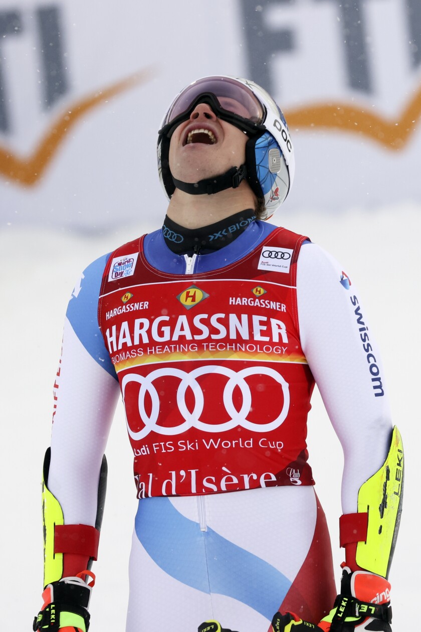 Switzerland's Marco Odermatt celebrates winning an alpine ski, men's World Cup giant slalom, in Val D'Isere, France, Saturday, Dec. 11, 2021. (AP Photo/Alessandro Trovati)