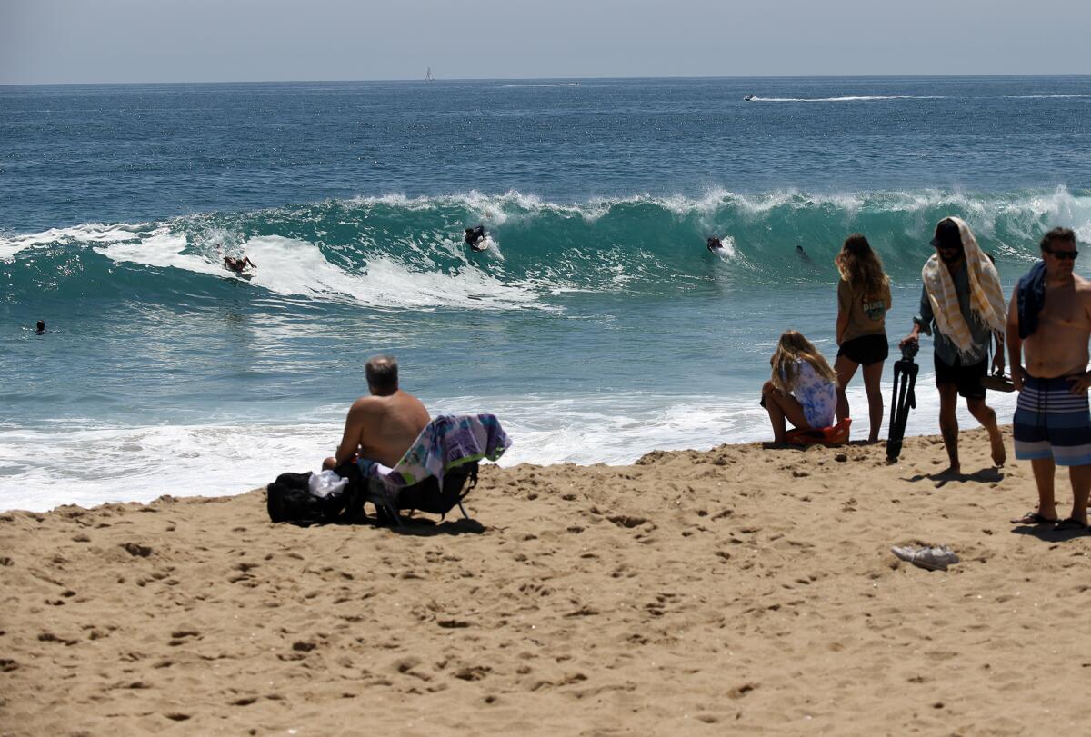 People watch the surfers at the Wedge in Newport Beach.