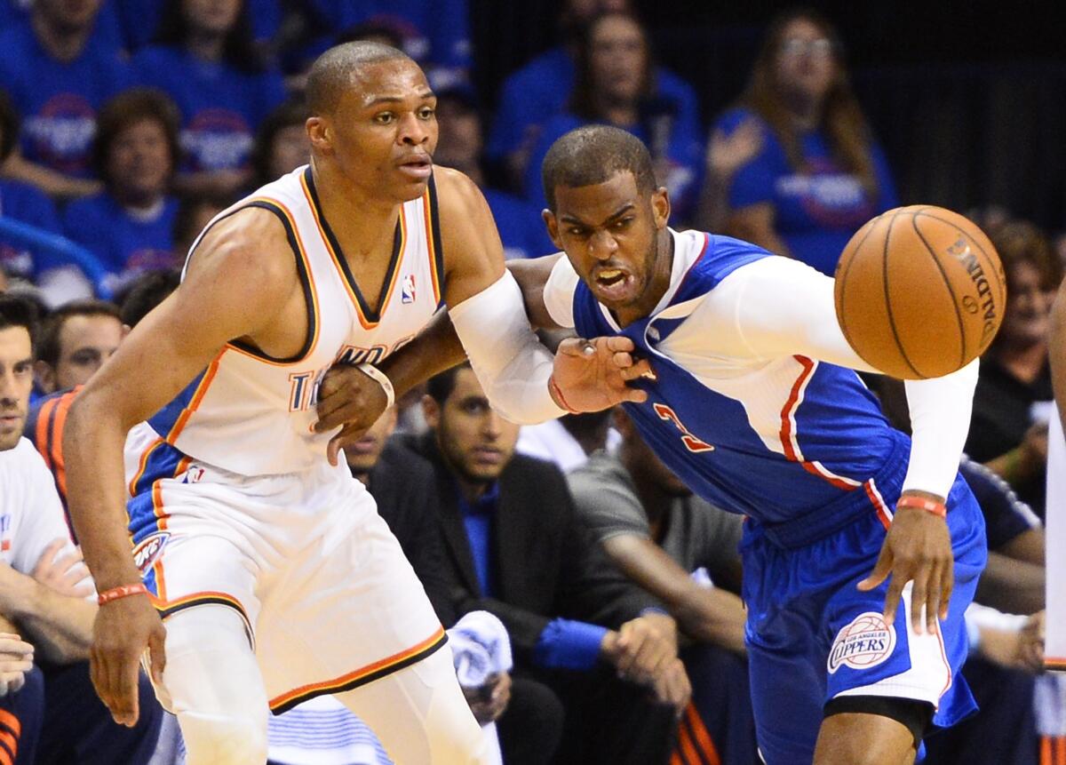 Point guards Russell Westbrook of the Thunder and Chris Paul of the Clippers go after a loose ball in the first half.