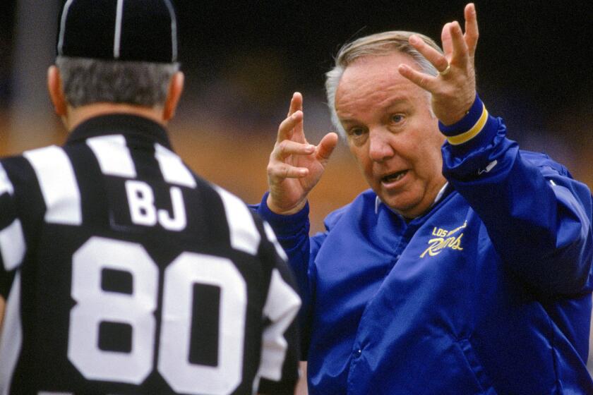 Rams Coach John Robinson argues a call with an official during a game against the Falcons on Dec. 8, 1991.