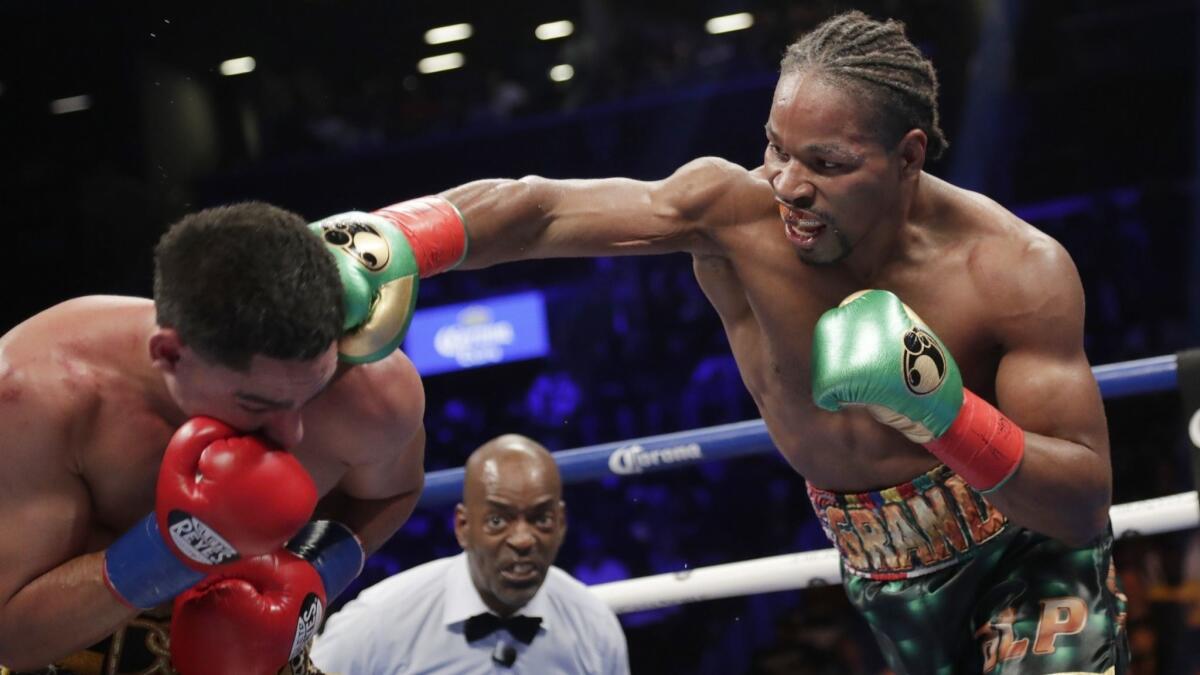 Shawn Porter, right, punches Danny Garcia during the eighth round.