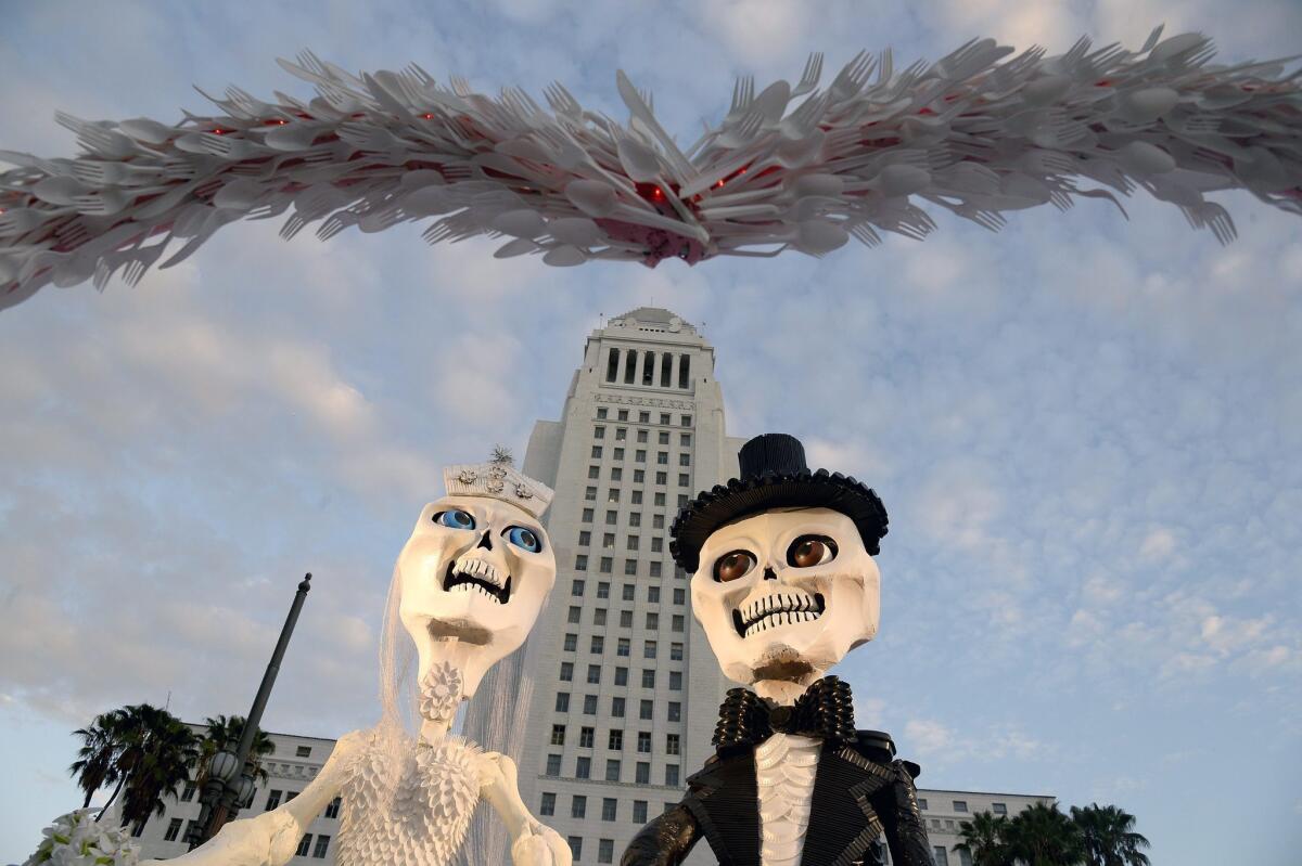 A 'Dia de los Muertos' (Day of the Dead) altar featuring a wedding couple created by Marcus Politz is displayed in front of City Hall in downtown Los Angeles.