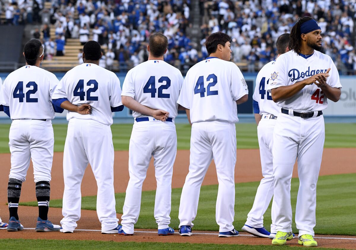 Kenley Jansen of the Los Angeles Dodgers lines up for the national anthem before a game against the Cincinnati Reds on Jackie Robinson Day 2019