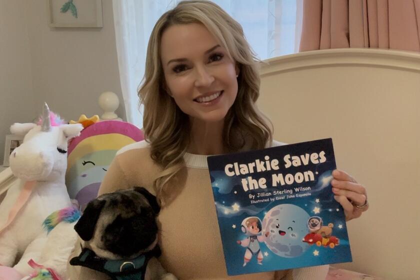 La Jolla resident Jillian Sterling Wilson, author of "Clarkie Saves the Moon," sits with her family dog, Willy.