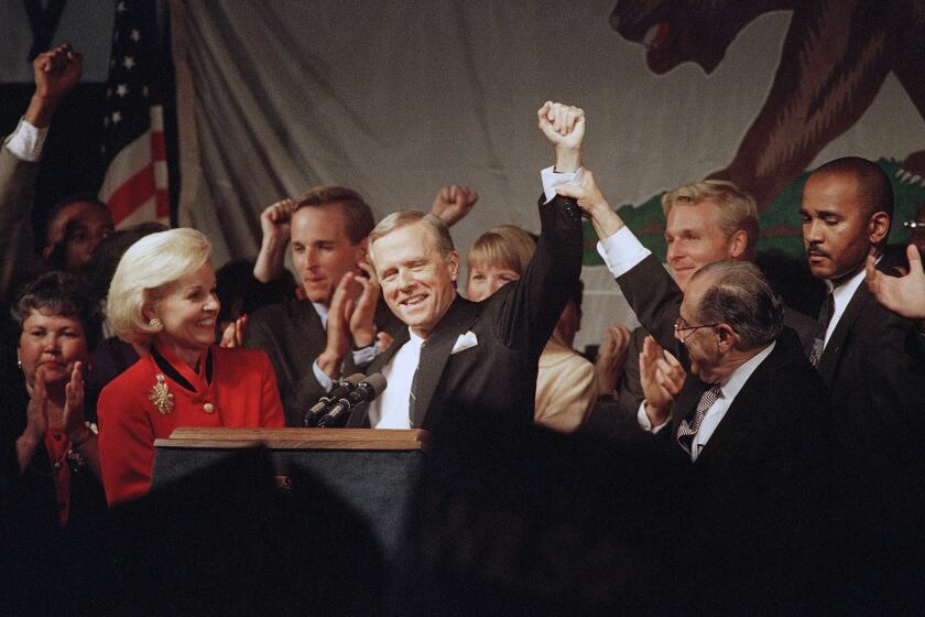 California Governor Pete Wilson, with his wife Gayle, has his hand raised in triumph by Californiaís Republican Party Chairman, Tiso Del Junco, at a Los Angeles hotel as he gives his acceptance speech for another term as governor, Tuesday, Nov. 8, 1994. (AP Photo/Kevork Djansezian)