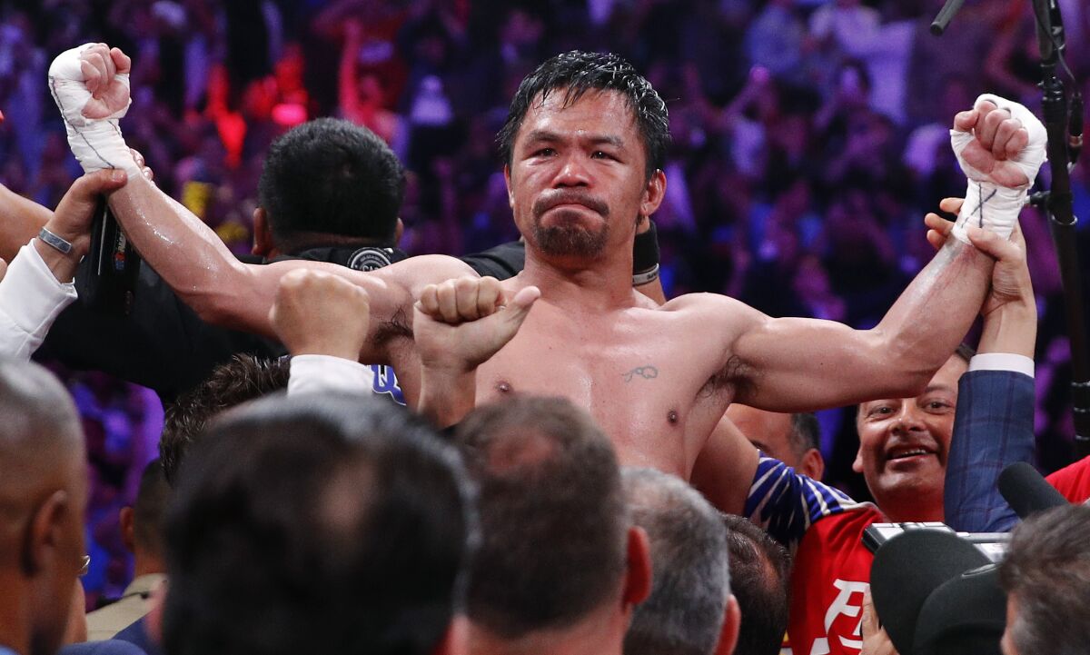 FILE - Manny Pacquiao reacts after defeating Keith Thurman by split decision in a welterweight title fight in Las Vegas, in this Saturday, July 20, 2019, file photo. Pacquiao could have canceled his comeback from a two-year ring layoff when Errol Spence Jr. dropped out less than two weeks before their Aug. 21 fight. Instead, the Filipino congressman gave a career-defining opportunity to Yordenis Ugás, a Cuban veteran who now has the welterweight title belt Pacquiao recently held. (AP Photo/John Locher, File)