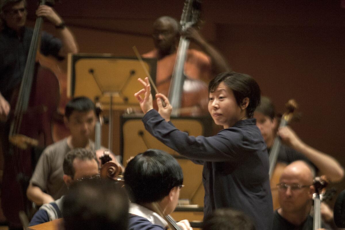 Conductor Xian Zhang directs musicians during a 'Chinese New Year: From Tchaikovsky to Tan Dun' rehearsal at Disney Concert Hall in Los Angeles.