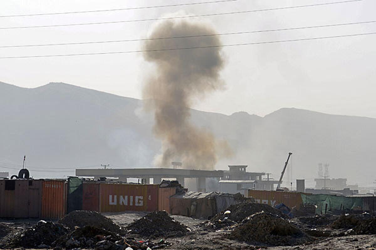 Smoke rises from a building where insurgents were believed to have holed up near Kabul airport.