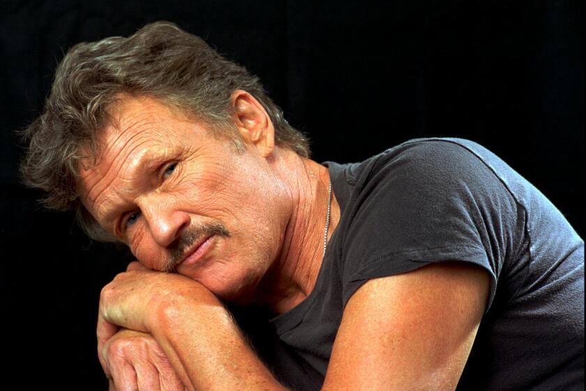 FILE - Kris Kristofferson poses for a portrait in Nashville, Tenn., on Aug. 15, 1995. Kristofferson has retired after five decades. A statement from his publicist said the Country Music Hall of Famer and Grammy winner retired in 2020. His son, John, stepped in last year to oversee his father's business including his record label. The Texas-born Oxford scholar brought introspective and poetic lyrics to country music with songs like “Sunday Mornin' Comin' Down” and “Me and Bobby McGee.” He was a member of the supergroup The Highwaymen and starred in 70 films over his career. (AP Photo/Mark Humphrey, File)