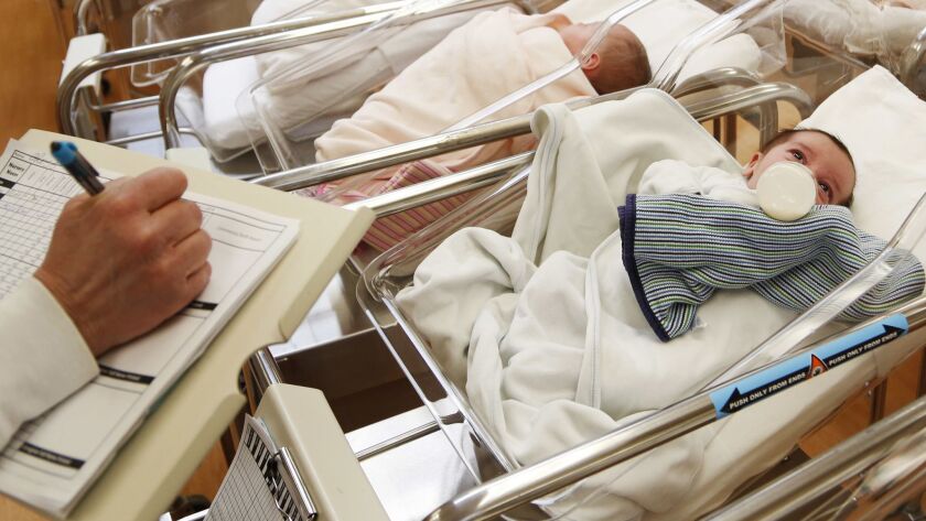 This Feb. 16, 2017 file photo shows newborn babies in the nursery of a postpartum recovery center in upstate New York. Women in the United States gave birth last year at the lowest rate in three decades, a trend that could weigh on economic growth in future decades.