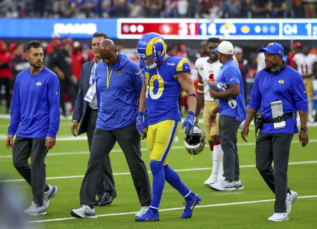 Rams wide receiver Cooper Kupp leaves the field with medical personnel after suffering an injury October 30, 2022.