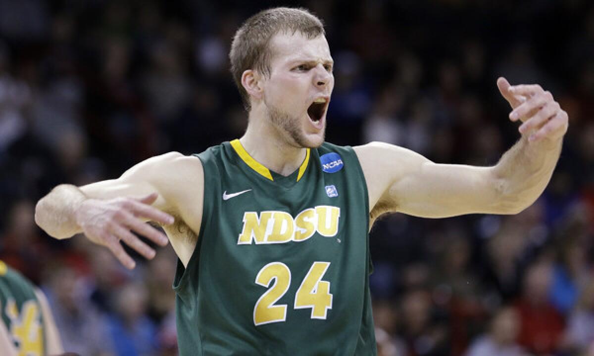 North Dakota State's Taylor Braun encourages fans to make some noise after scoring a basket during the Bison's upset victory over Oklahoma in the second round of the NCAA tournament Thursday.