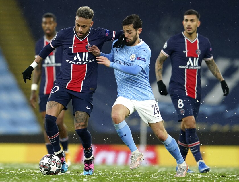 Manchester City's Bernardo Silva, center, challenges PSG's Neymar during the Champions League semifinal second leg soccer match between Manchester City and Paris Saint Germain at the Etihad stadium, in Manchester, Tuesday, May 4, 2021. (AP Photo/Dave Thompson)