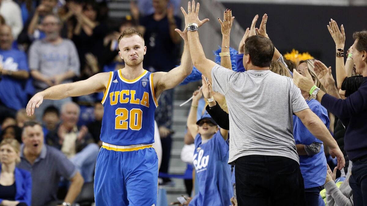 Guard Bryce Alford (20) high-fives fans after making a three-point shot against the Trojans during the second half of the Bruins' 102-70 win at Pauley Pavilion on Saturday.