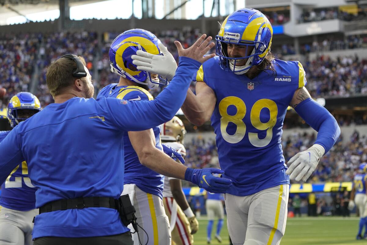 Rams tight end Tyler Higbee celebrates with coach Sean McVay after catching a touchdown pass in the first half.