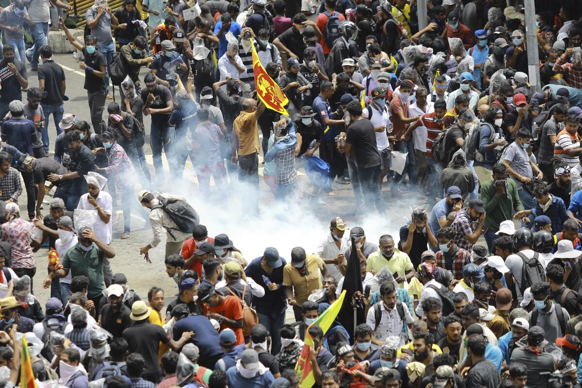 Protesters are hit by a cloud of tear gas in Sri Lanka. 