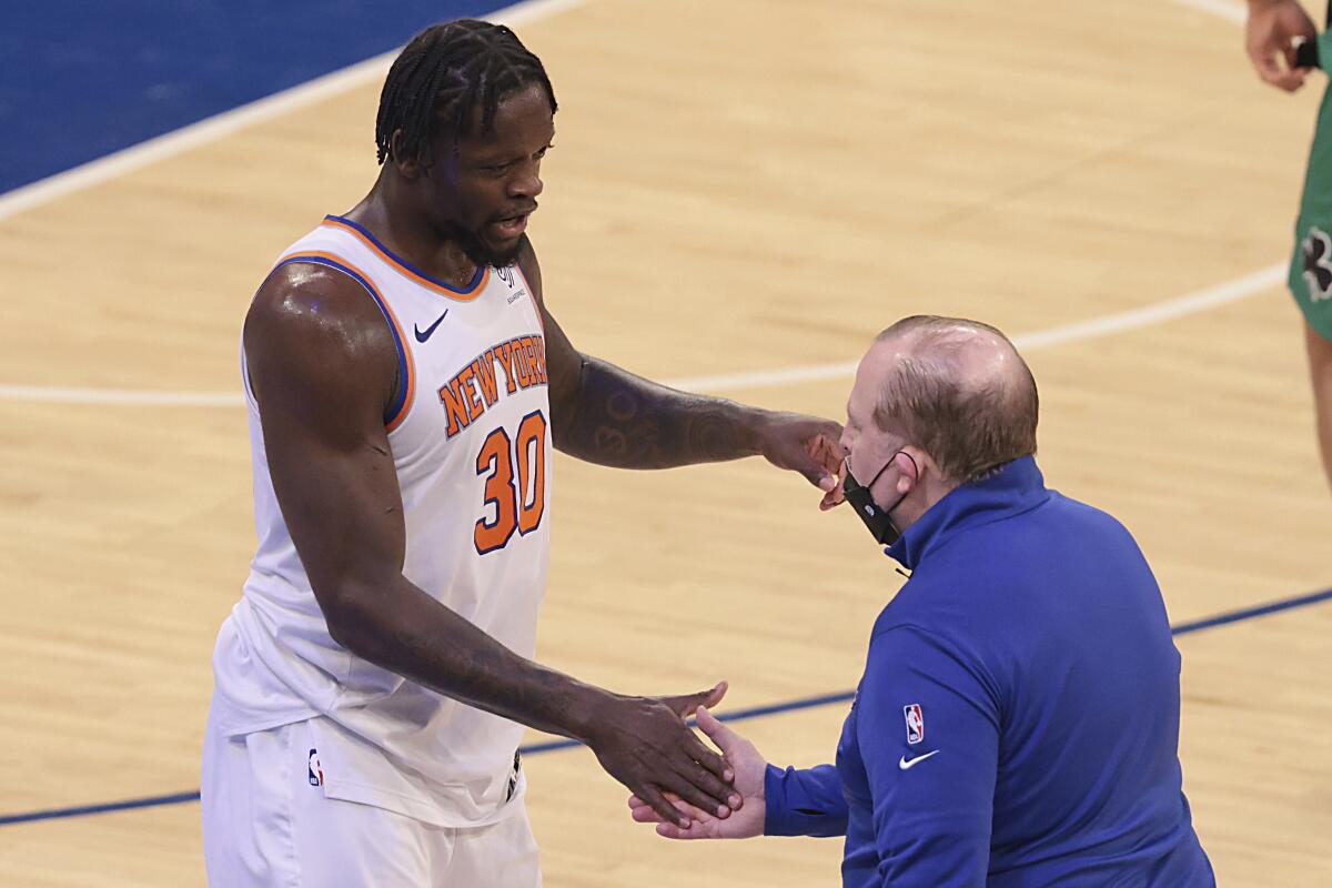 New York Knicks forward Julius Randle (30) celebrates with head coach Tom Thibodeau.