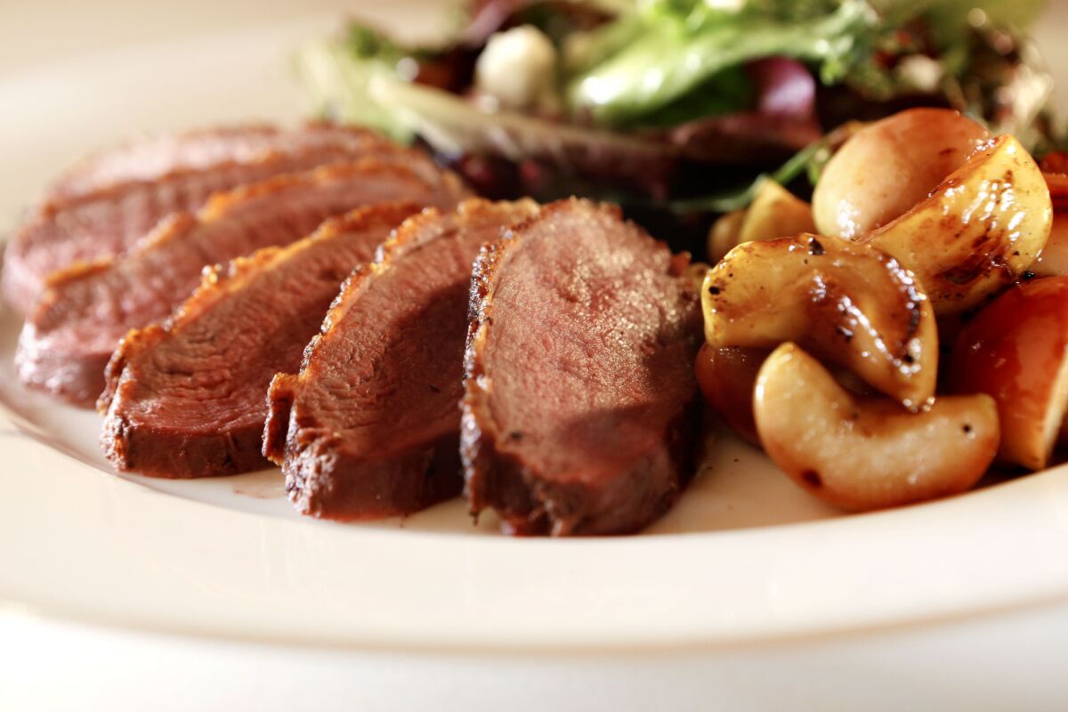 Sauteed duck breast with apples and tart greens in the Los Angeles Times studio on Oct. 8, 2015.