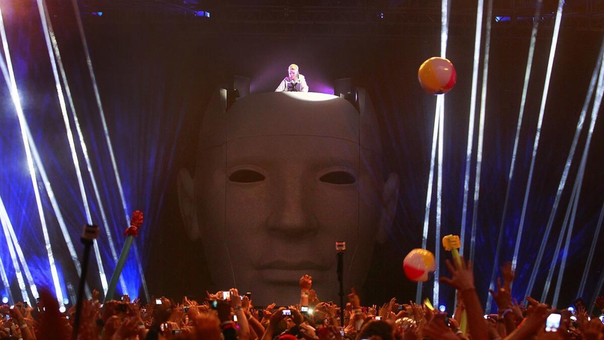 Avicii plays music from atop a giant head at the Coachella Festival in 2012.