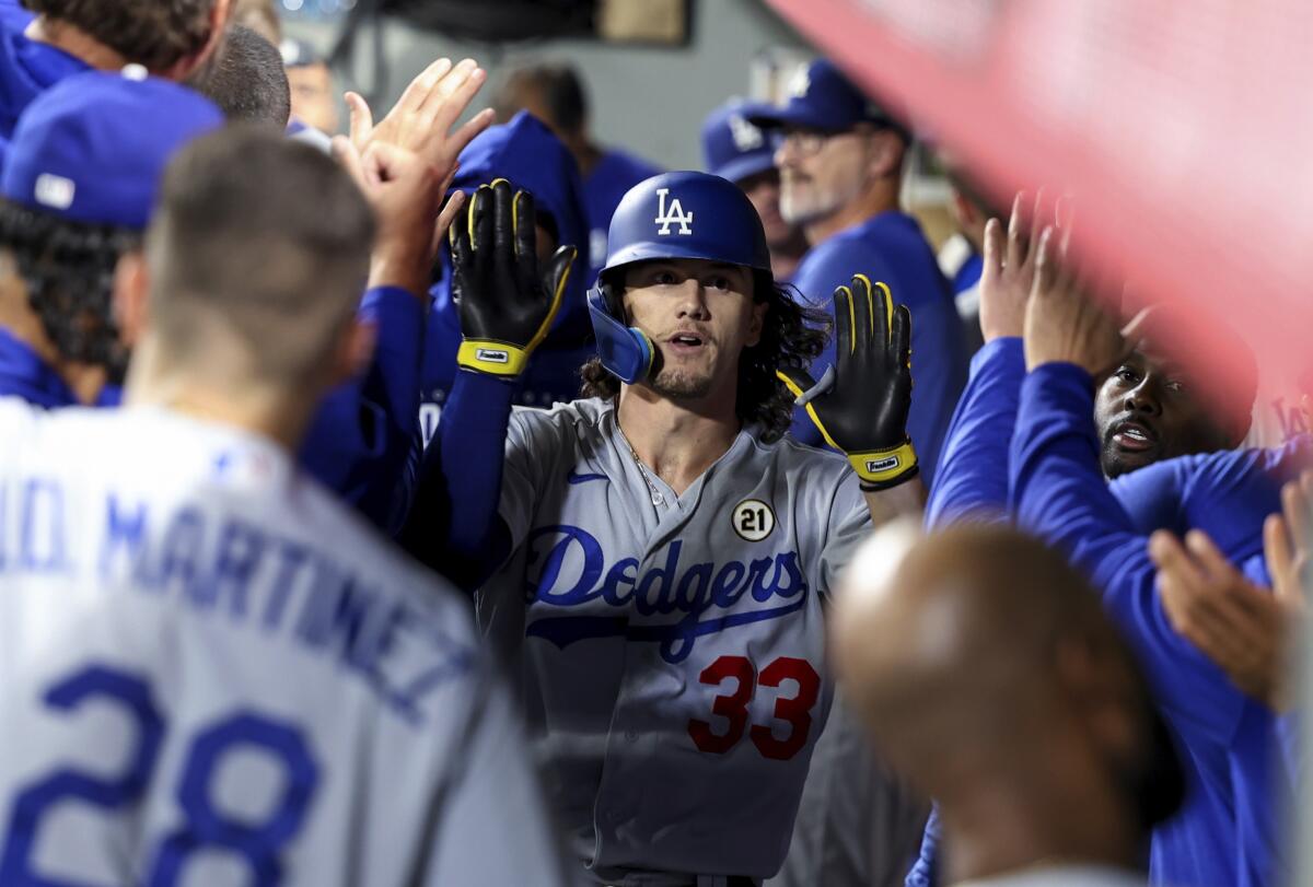 James Outman celebrates in the Dodgers' dugout after hitting a home run in the ninth inning Friday against Seattle.