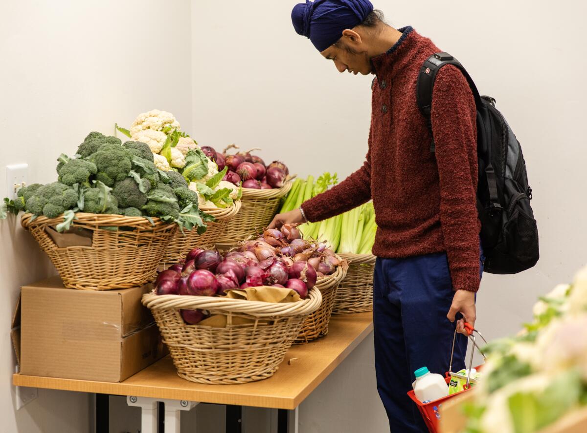 A man picks out vegetables at Orange Coast College as part of Second Harvest Food Bank's college pantry program.